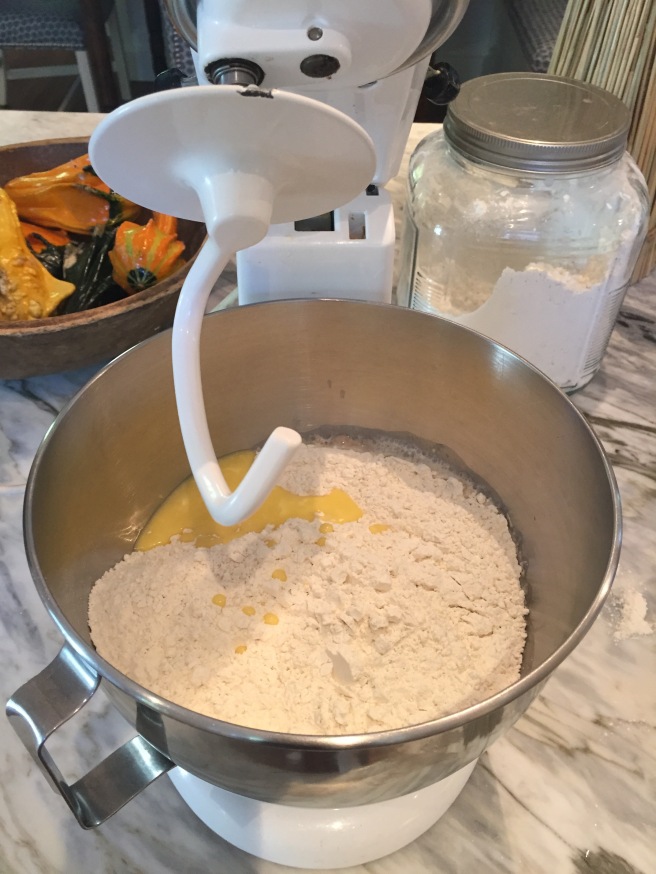 Adding flour and melted butter to yeast mixture
