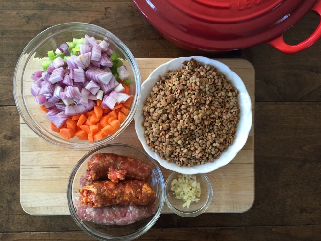 Carrots, celery, onions, garlic, sausage and lentils with dutch oven