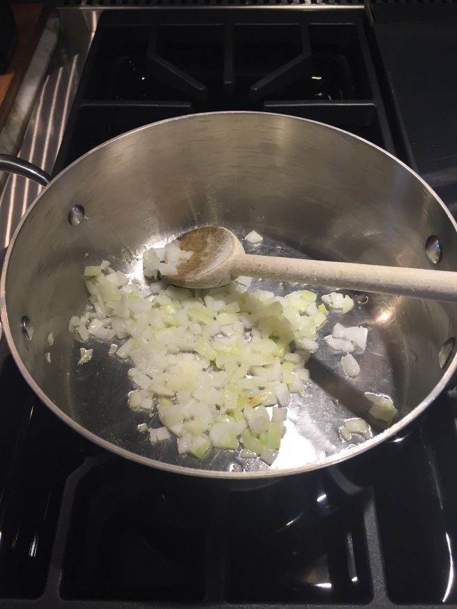 Wilting finely chopped onion in saucepan.