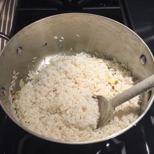 Stirring rice to coat in saucepan