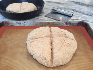Brown Soda Bread dough cut with deep cross on lined cookie sheet